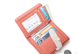 Detail view of pink leather wallet showing card slots, photo ID window and currency compartment