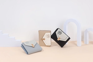 Short tri-fold floral wallets in light blue, beige, and black with elegant gold hardware