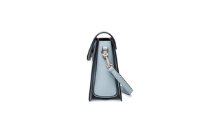 Side view of light blue PU leather crossbody bag showing trapezoid shape and golden hardware