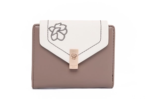 Detailed view of women's tri-fold PU wallet with floral embroidery and metal buckle