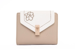 Macro detail of beige PU leather wallet featuring floral embroidery and rose gold clasp