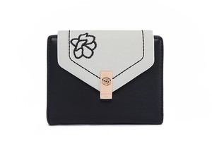 Close-up of trifold wallet featuring flower embroidery and a rose-shaped metal buckle