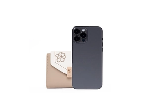 Compact women's tri-fold floral wallet shown next to a smartphone for size reference