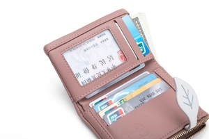 Detail view of pink leather wallet featuring multi-card slots and a clear ID window