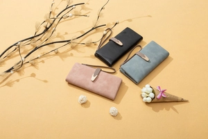 Detailed view of matte PU leather long wallets with metallic buckle and wristlet strap
