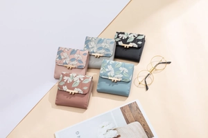 Detail of floral printed PU leather trifold wallets with metallic lucky bar closure