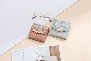 Close-up of trifold floral wallets with golden PRETTYZYS metal bar and secure clasp