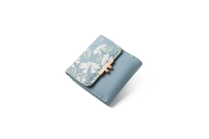 Macro view of blue PU leather wallet with floral print and gold bead clasp closure