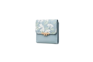 Close-up of light blue trifold wallet with floral print flap and gold metallic clasp