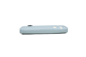 Detail of light blue floral wallet with white daisy pattern and smooth zipper texture