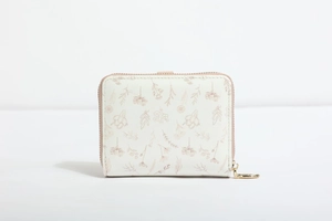 Detailed view of the smooth metal zipper and floral print on this compact women's purse