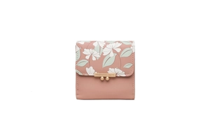 Macro view of pink PU leather wallet with floral print and gold PRETTYZYS LUCKY clasp