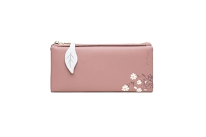 Detail of floral print pattern and white leaf-shaped zipper pull on pink leather wallet