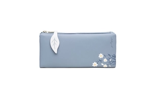 Detail showing elegant grey-blue wallet featuring leaf-shaped zipper pull and daisy print