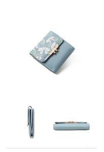 Macro view of light blue floral PU leather wallet with gold buckle and precise stitching