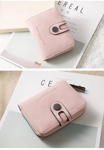 Close-up of pink PU leather wallet showing matte texture and snap closure details