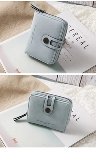 Close-up of light blue PU leather wallet featuring a zipper coin pocket and snap closure