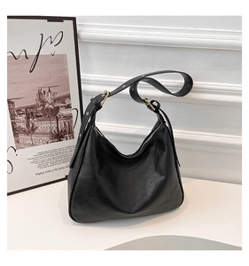 Detail view of the black crescent hobo bag featuring premium leather and gold hardware