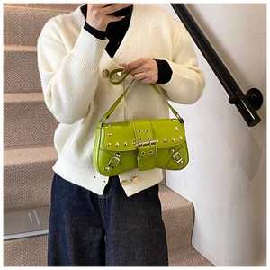 Detail of lime green faux leather shoulder bag with silver studs in Y2K vintage style