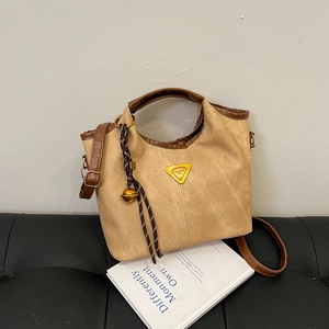Khaki canvas bucket bag with contrast brown trim and adjustable shoulder strap