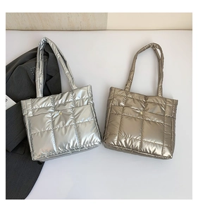 Top view of quilted silver and champagne down puffer tote bags for women's fashion