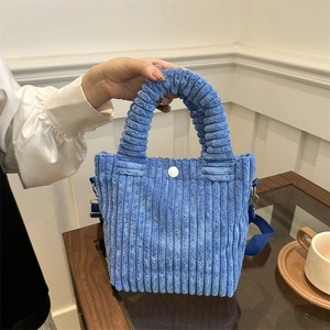 Sky blue corduroy bucket bag with pleated handle and white button closure for women