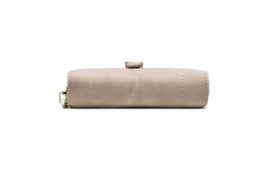 Detail of light brown matte leather wallet with fine stitching and golden zipper pull
