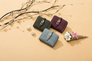 Close-up of frosted short wallets with metallic leaf buckle and zipper detail