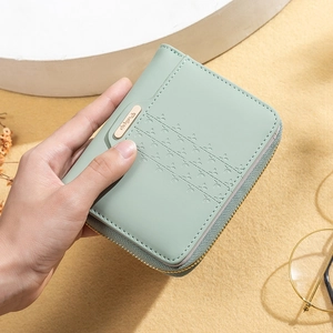 Detailed view of mint green PU leather wallet with floral stitching and golden metal logo