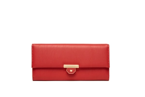 Detail of red pebbled leather long wallet featuring a gold heart clasp and logo