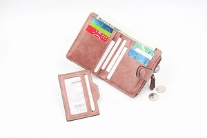 Detail view of pink PU leather bi-fold wallet interior with multiple card slots and coin pocket