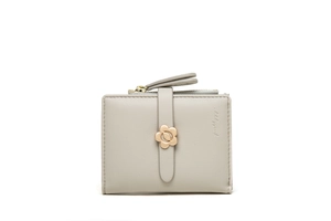 Detailed view of light gray short wallet featuring lychee texture and gold flower clasp