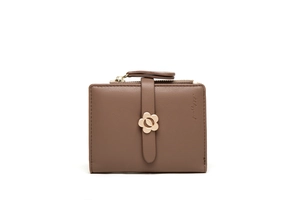 Close-up of brown leather wallet with golden flower clasp and zipper closure
