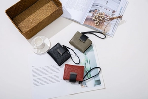 Three compact PU leather wallets with geometric texture and elegant hand straps