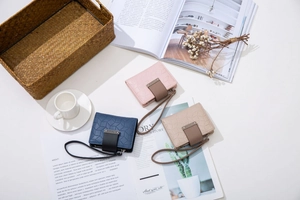 Detailed view of PU leather wallets with geometric stitching and wrist straps