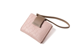Detail of pink and brown PU leather wallet with geometric embossing and wrist strap