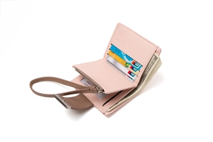 Interior of pink short bi-fold wallet showing multiple card slots and silver zipper pocket