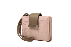 Macro detail of pink PU leather wallet with geometric embossing and metal brand tag