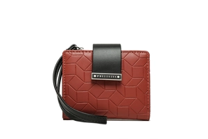 Macro detail of geometric embossed PU leather wallet with wristlet strap and silver plaque