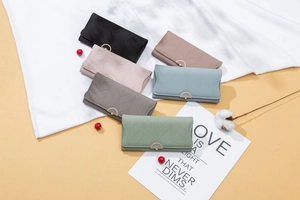Detailed view of long PU leather wallets with geometric leaf stitching and metal buckles