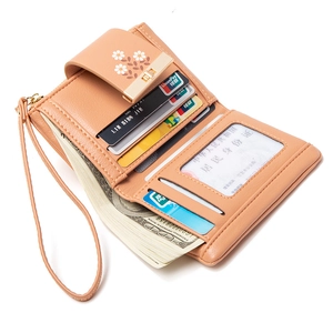 Beige trifold PU wallet with daisy print and multiple card slots showing interior
