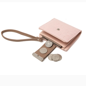 Short pink PU leather women wallet with geometric texture and wrist strap on white background