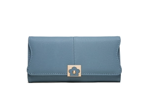 Close-up of navy blue long wallet featuring white stitching and gold floral buckle detail
