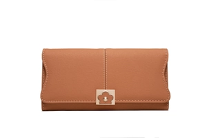 Detail of tan long wallet with floral gold clasp and decorative white stitching on leather