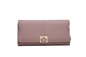 Close-up of pink long wallet featuring golden floral clasp and wavy edge detail