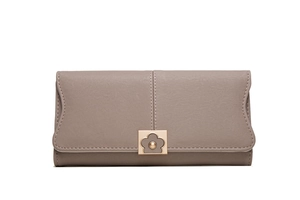 Close-up of taupe long wallet with fine leather texture and golden floral metal buckle