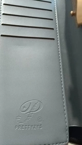 Detail view of leather wallet interior with multiple card slots and stitched seams