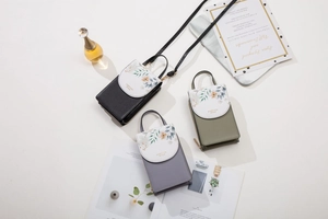Detailed view of floral printed multi-functional PU leather mini cross-body phone bags