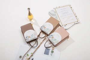 Three elegant PU leather crossbody phone bags with floral prints in brown and pink