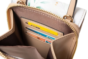 Close-up of internal card slots and zipper structure in a patterned crossbody phone bag
